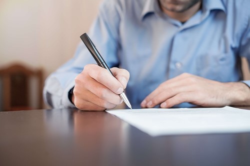 employee making notes by hand