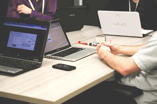 An employee working on his laptop at his desk.