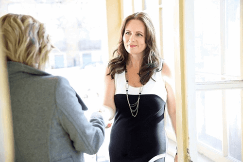 two people shaking hands before a business meeting