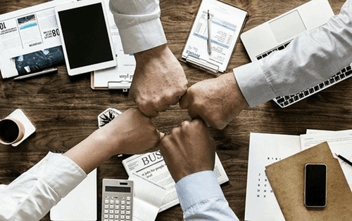 Employees fist-bumping each other