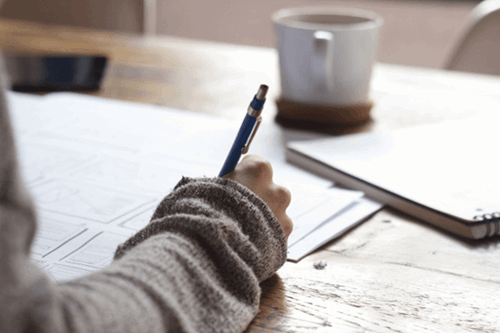 A worker writing on a desk