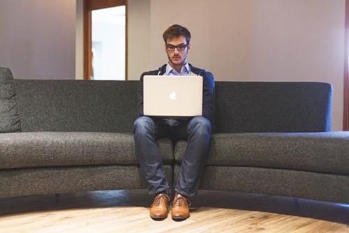 man working on his laptop alone