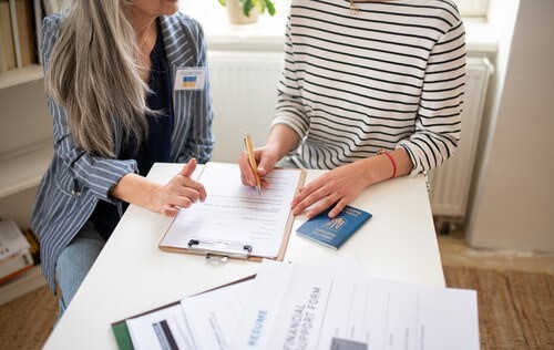 Two people looking over papers.