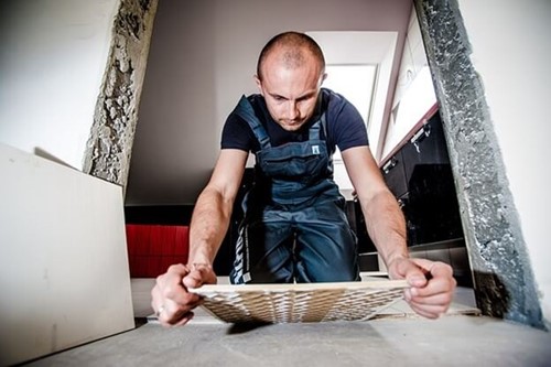 a tradesperson laying tiles