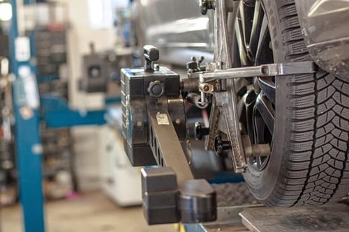 a car raised on a jack in a workshop