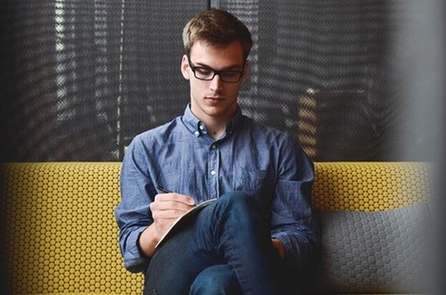 A man making notes in a notebook