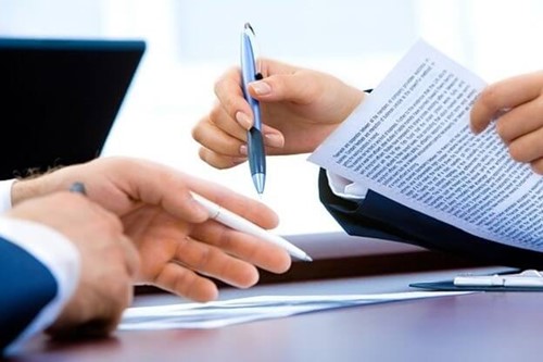 Two people looking at paperwork