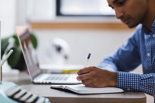 An employee making notes while working