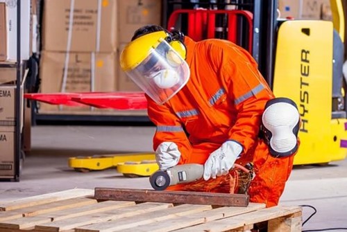 An employee using power tools in full PPE