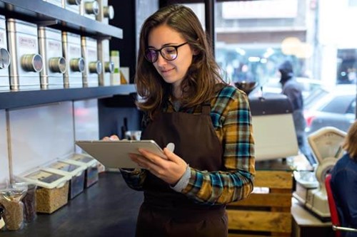 a retail worker using a computer tablet