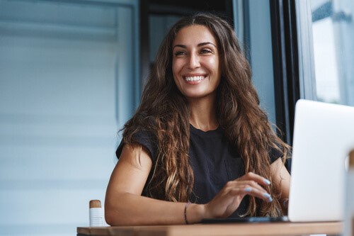 An employer smiling after hiring a new employee