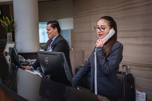 a receptionist using a phone