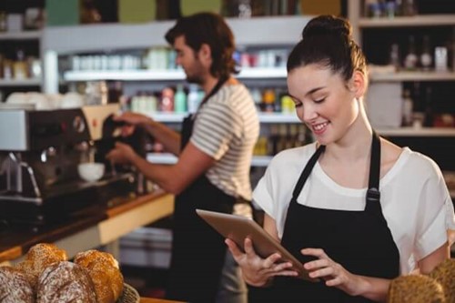 a cafe worker using a tablet